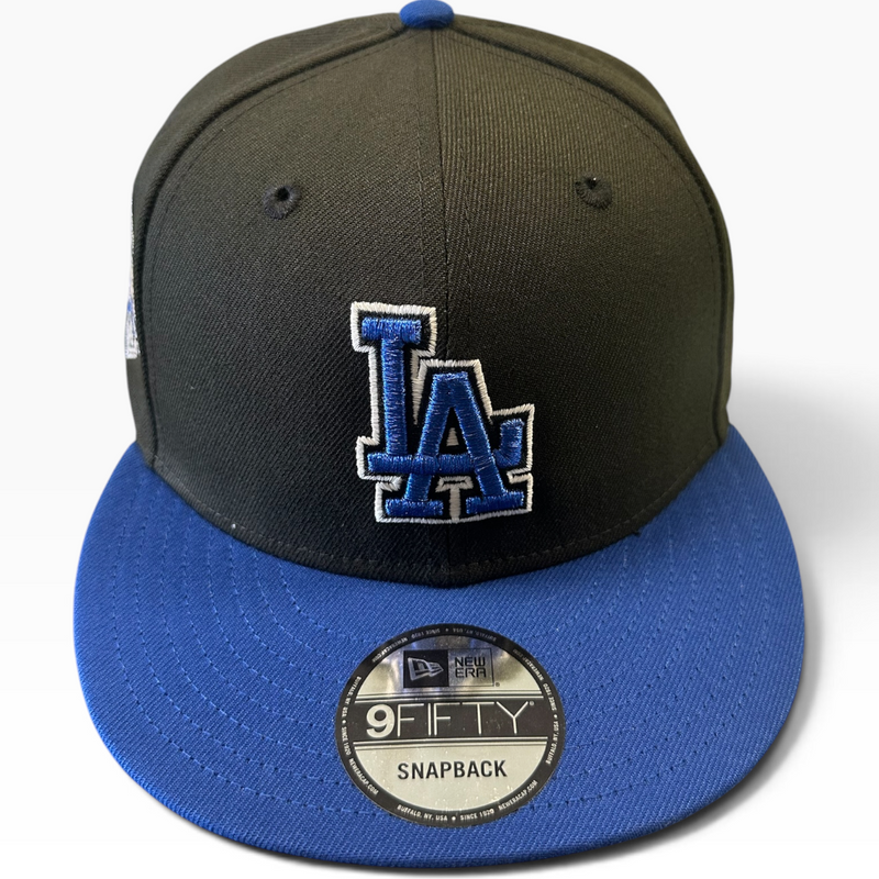 Los Angeles Dodgers black and royal blue 9FIFTY snapback hat with World Champions side patch - front view